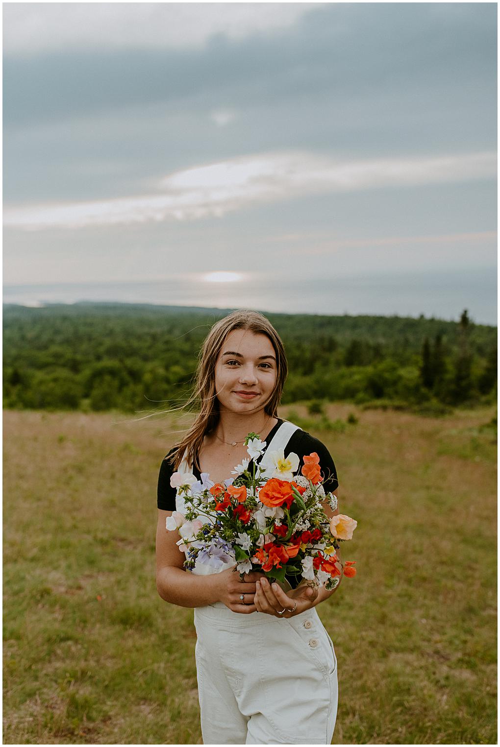 Wisconsin Senior Photographer taking senior pictures in Copper Harbor, Michigan. Flower bouquet by Wander Wild Farm in Eagle River, Wisconsin